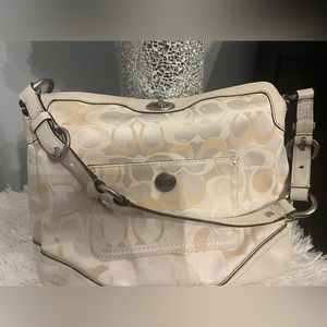 Cream colored shoulder bag.